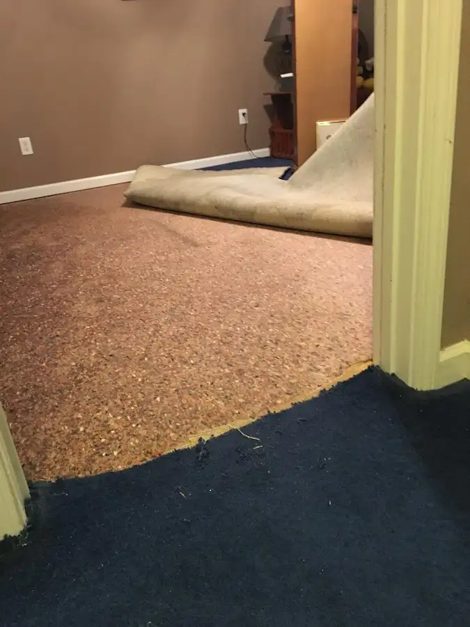 Carpet pad removal revealing water damage during Drying & Dehumidification in Leavenworth